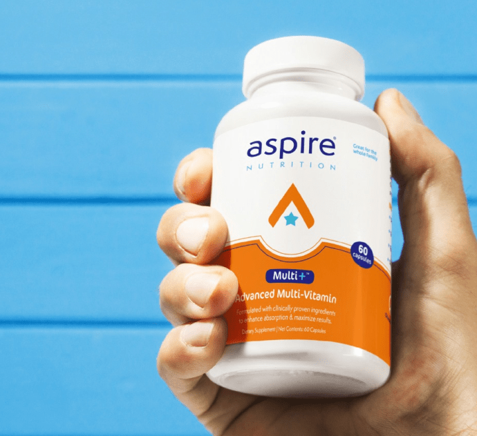 Hand holding a bottle of Multi+ advanced multi vitamins