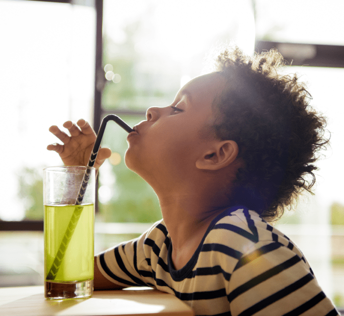 Boy drinking a healthy green juice