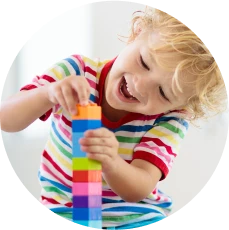 Young child playing with building blocks